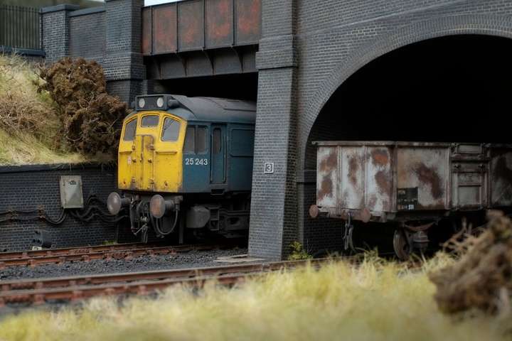 A class 31 loco and 16T mineral wagon under the road bridges
