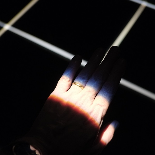 A hand light by narrow strips of light